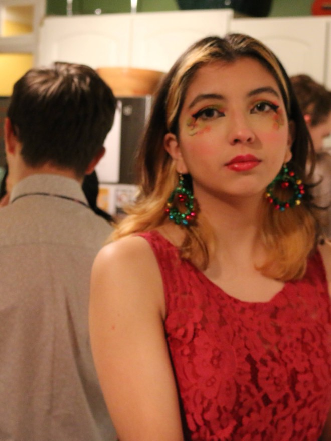 Megan in a red dress with large statement earrings
